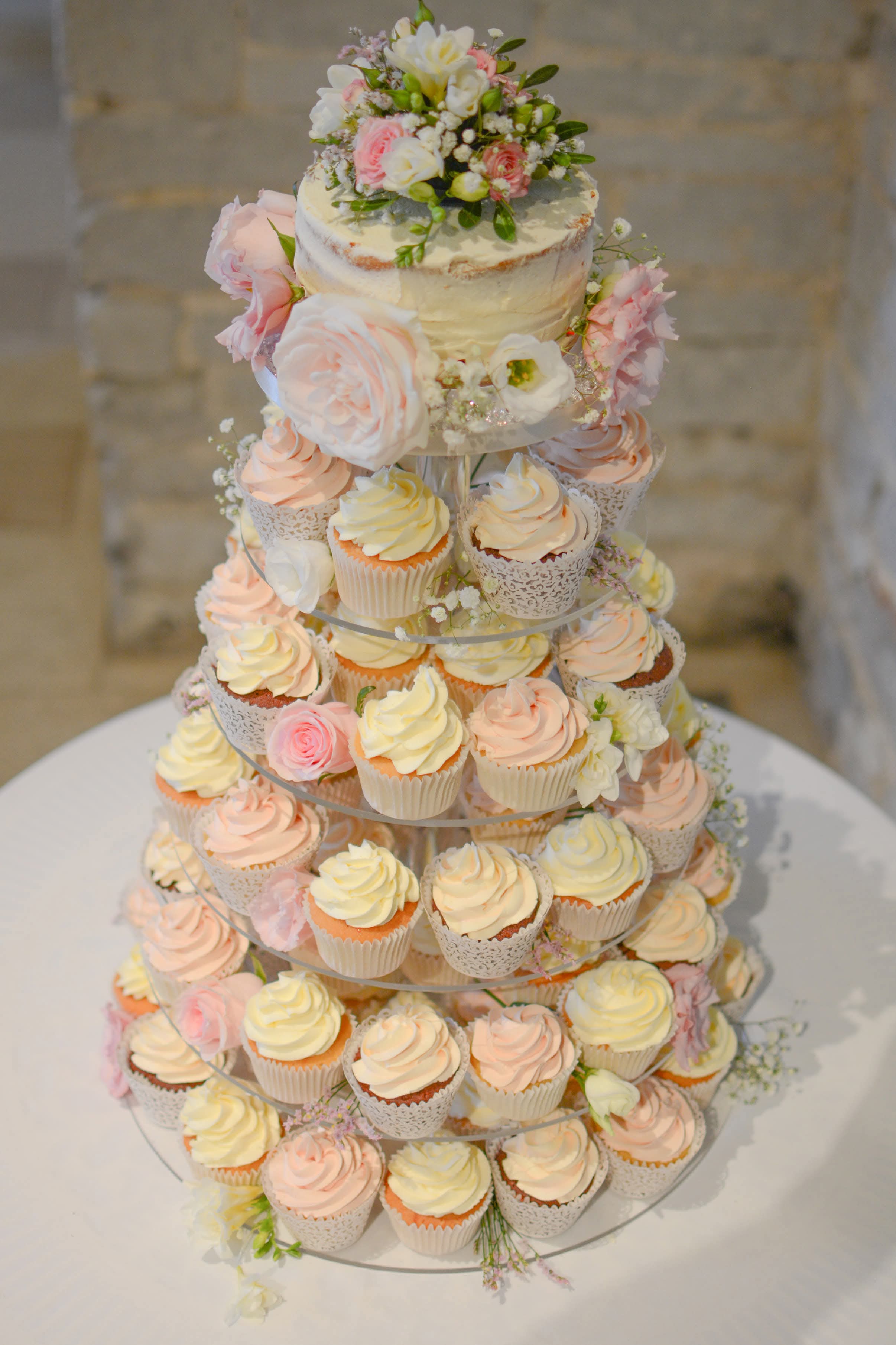 Cupcake tower display with decorative cupcake wrappers