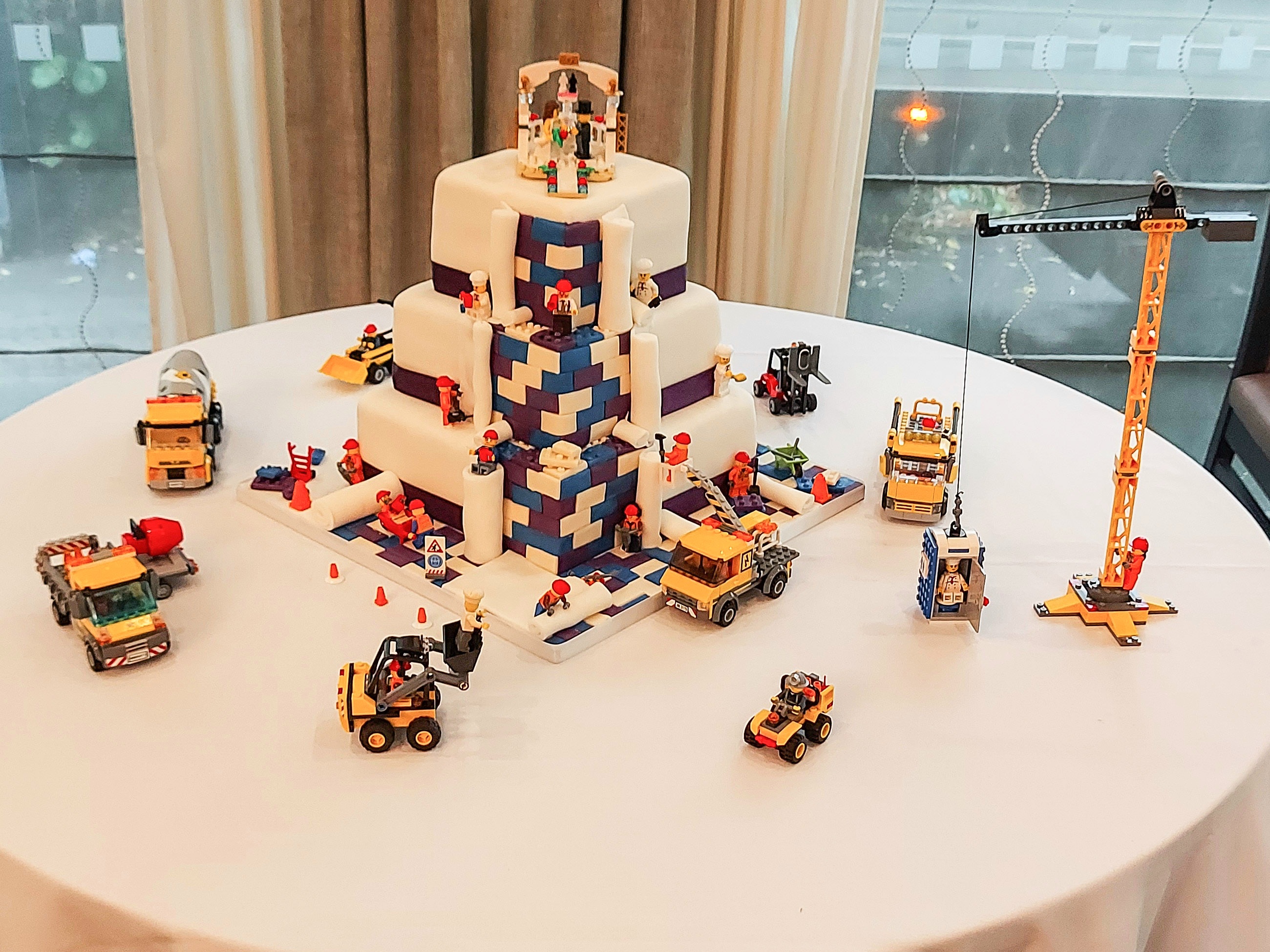 Lego construction-themed wedding cake with real Lego figures