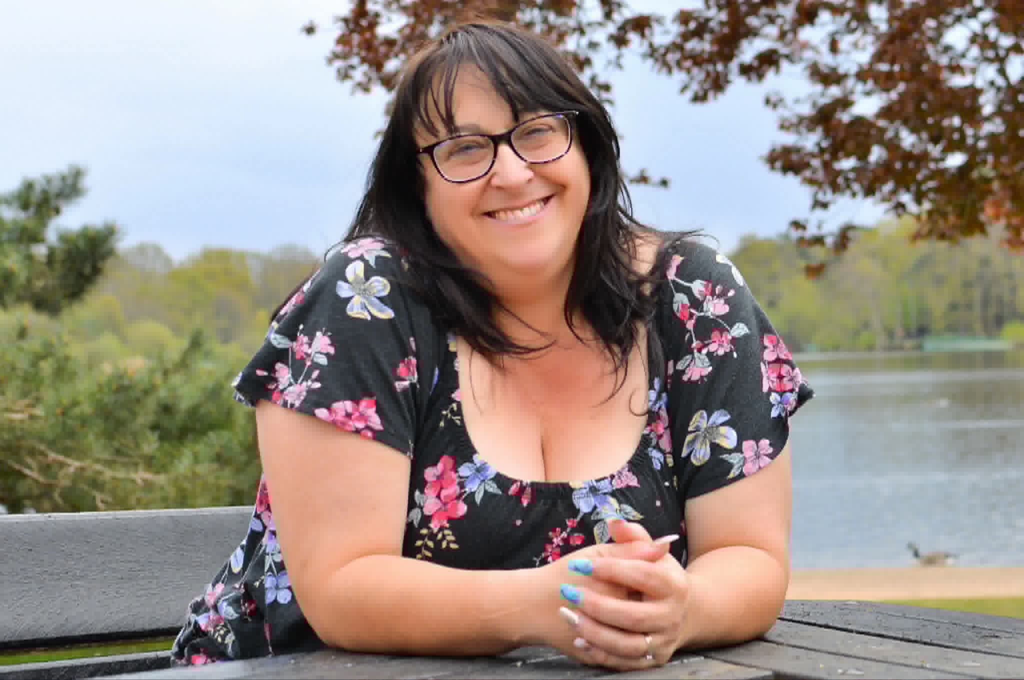 Jayne smiling beside the lake